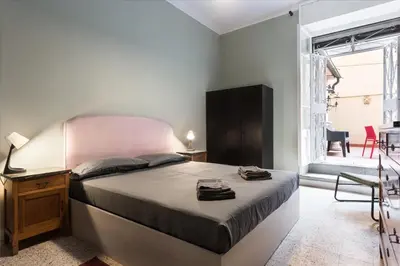 a bedroom with a large bed and a large window at Angelico Vatican Apartment by Oneup Hospitality in Rome