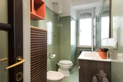 a bathroom with a toilet and a sink at Angelico Vatican Apartment by Oneup Hospitality in Rome