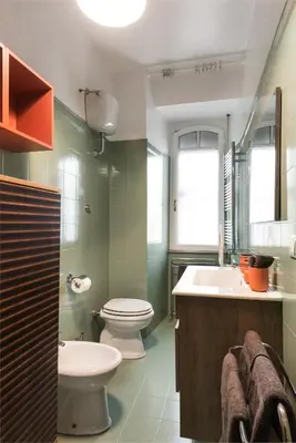 a bathroom with a toilet and a sink at Angelico Vatican Apartment by Oneup Hospitality in Rome