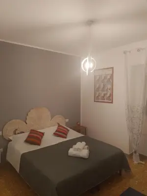 a bedroom with a bed with two towels on it at Urban cosy rooms in Rome