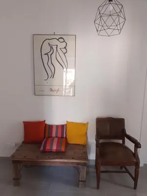 a bench and a chair in a room at Urban cosy rooms in Rome