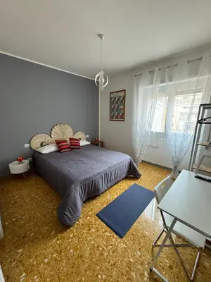 a bedroom with a bed and a chair in it at Urban cosy rooms in Rome