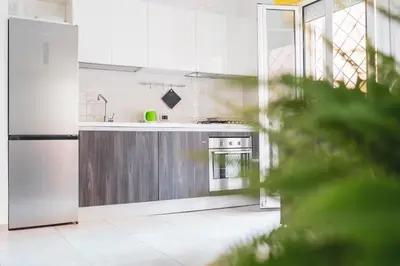 a kitchen with a refrigerator and a stove at Maison Balduina in Rome