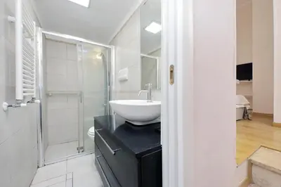 a bathroom with a white sink and a shower at Vaticano in Rome