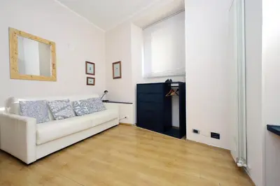 a living room with a white couch and a mirror at Vaticano in Rome