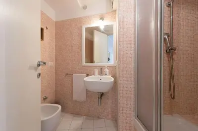 a bathroom with a sink and a toilet and a shower at Casa Bartolomeo - Loft in Trastevere in Rome