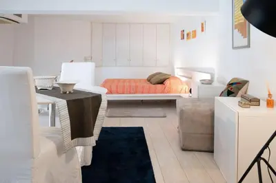 a bedroom with a bed and a table in it at Casa Bartolomeo - Loft in Trastevere in Rome