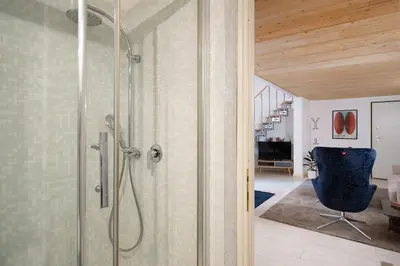 a bathroom with a shower with a glass door at Casa Bartolomeo - Loft in Trastevere in Rome