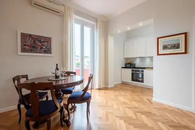 a kitchen with a table and chairs in a room at Top View Luxury apartment Piazza del Popolo in Rome