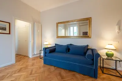 a blue couch in a living room with a mirror at Top View Luxury apartment Piazza del Popolo in Rome