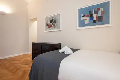 a bedroom with a bed and two pictures on the wall at Top View Luxury apartment Piazza del Popolo in Rome