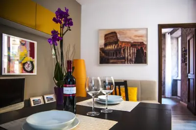 a table with two glasses and a bottle of wine at Casa Federico - beauty apartment with wonderful terrace in Rome