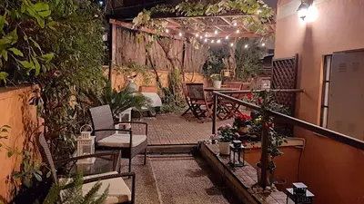 a patio with a table and chairs and plants at Casa Federico - beauty apartment with wonderful terrace in Rome