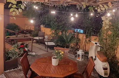 a scooter parked in a patio with a table and chairs at Casa Federico - beauty apartment with wonderful terrace in Rome