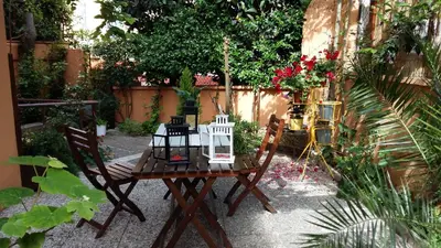 a table with two chairs and a lamp on it at Casa Federico - beauty apartment with wonderful terrace in Rome