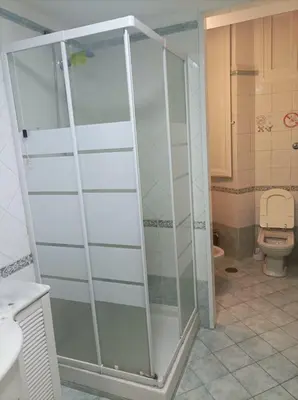 a glass shower in a bathroom with a toilet at Minerva Rooms in Rome