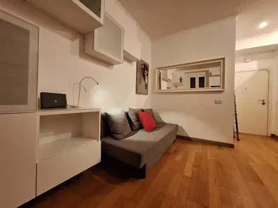 a living room with a couch with a red pillow at Casa Vidaschi in Rome