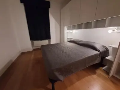 a bedroom with a bed and a wooden floor at Casa Vidaschi in Rome