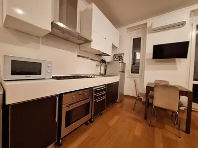 a kitchen with a counter and a table and a microwave at Casa Vidaschi in Rome