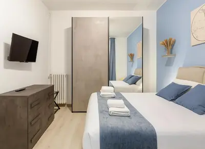 a bedroom with a bed and a dresser and a tv at RomeSweetHome Villa Borghese in Rome