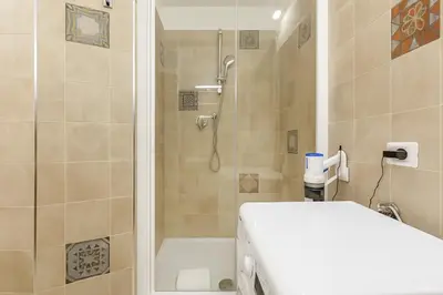 a bathroom with a shower and a toilet at RomeSweetHome Villa Borghese in Rome