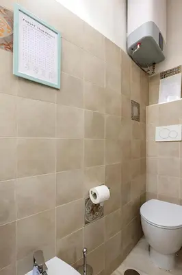 a bathroom with a toilet and a sign on the wall at RomeSweetHome Villa Borghese in Rome