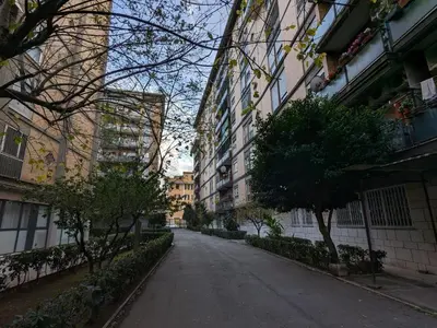 an empty street in a city with tall buildings at SyrakaHost Intero appartamento in Rome