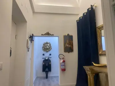 a hallway with a blue door with a fire hydrant at New opening Sweet Apartament Trastevere in Rome
