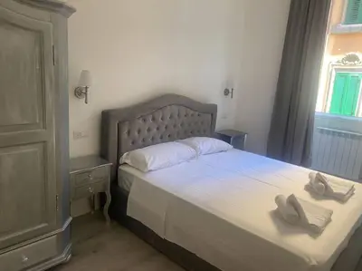 a bedroom with a bed with two towels on it at New opening Sweet Apartament Trastevere in Rome
