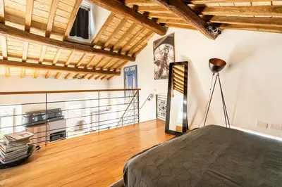 a bedroom with a bed and a wooden floor at Palazzo Centini Toni - Rome with style in Rome