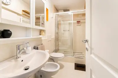 a bathroom with a sink and a toilet and a shower at Palazzo Centini Toni - Rome with style in Rome