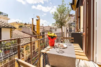a balcony with a table and a vase of flowers at Palazzo Centini Toni - Rome with style in Rome
