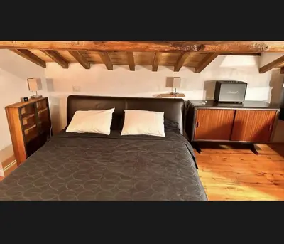 a bedroom with a black bed and a tv at Palazzo Centini Toni - Rome with style in Rome