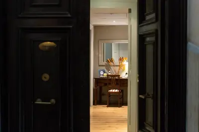 a hallway with a black door and a desk at Residenza Ottaviani Roma in Rome