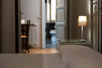 a bedroom with a bed and a table with a lamp at Residenza Ottaviani Roma in Rome