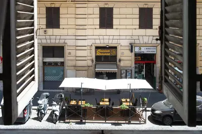 a table with motorcycles parked in front of a building at Residenza Ottaviani Roma in Rome