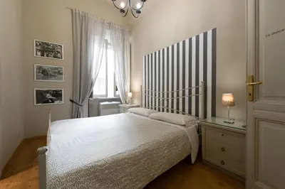 a bedroom with a large bed and a window at Residenza Ottaviani Roma in Rome