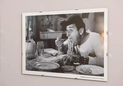 a man sitting at a table eating spaghetti at Residenza Ottaviani Roma in Rome
