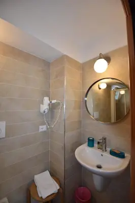 a bathroom with a shower and a toilet and a sink at Vassallo B&B in Rome