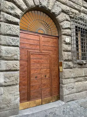 a large wooden door in a stone building at Navona Rhome in Rome