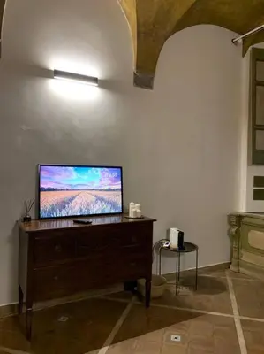 a living room with a flat screen tv on a dresser at Navona Rhome in Rome