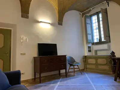 a living room with a tv and a chair at Navona Rhome in Rome