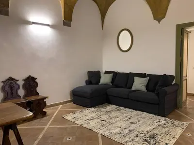 a living room with a couch and a mirror at Navona Rhome in Rome