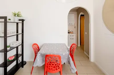a dining room with a table and red chairs at Dolcevita San Lorenzo luxury in Rome