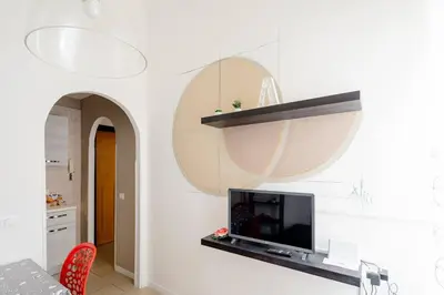 a living room with a flat screen tv on a wall at Dolcevita San Lorenzo luxury in Rome