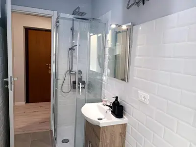 a white bathroom with a sink and a shower at Casa Paolina a Metro San Paolo in Rome