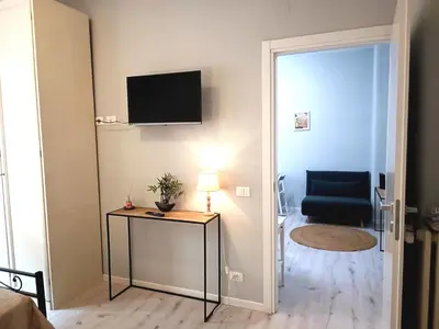 a room with a table and a chair and a television at Casa Paolina a Metro San Paolo in Rome