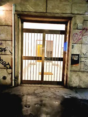 an open gate in a building with graffiti at Casa Paolina a Metro San Paolo in Rome