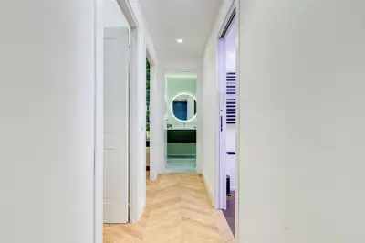 a hallway with white walls and a purple door at The Heart of Rome Luxury House in Rome