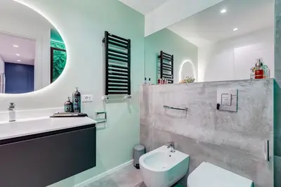 a bathroom with a sink and a toilet and a mirror at The Heart of Rome Luxury House in Rome